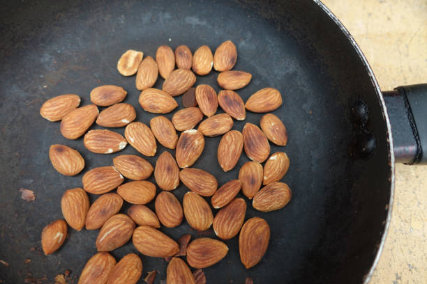 Almonds roasted in the pan stock photo