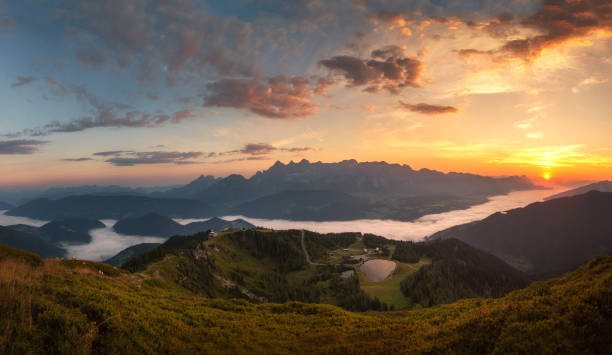Alps at sunrise with fog Dachstein massif with fog in the valley and sunrise dachstein mountains stock pictures, royalty-free photos & images