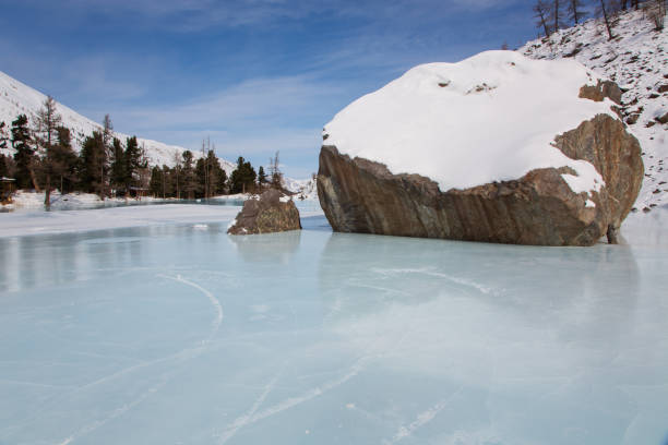 Altai mountain frozen lake with big stones stock photo