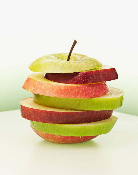 Alternating red and green apple slices  apple fruit stock pictures, royalty-free photos & images