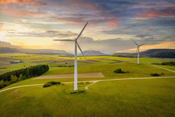 Alternative Energy Wind Turbine Green Landscape at Sunset Aerial drone point of view of modern wind turbines in green rural landscape during a colorful sunset twilight. Green Energy, Alternative Energy Environment Concept Shot. Baden Württemberg, South Germany, Europe wind turbine stock pictures, royalty-free photos & images