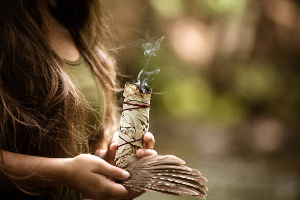 Alternative Medecine, Young Woman Performing A Purification Ritual With Sage Young caucasian woman burning sage, practicing a purification ritual ceremony stock pictures, royalty-free photos & images