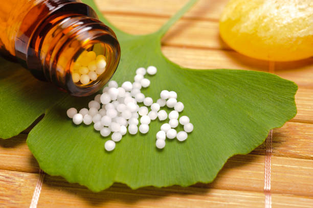alternative medicine with homeopathic pills on ginkgo leaf alternative medicine with homeopathic pills on ginkgo leaf homeopathic medicine stock pictures, royalty-free photos & images