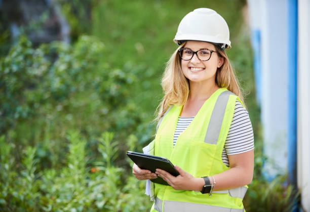 I am responsible to this site Shot of a female engineer with digital tablet working at a reconstruction project site project manager stock pictures, royalty-free photos & images