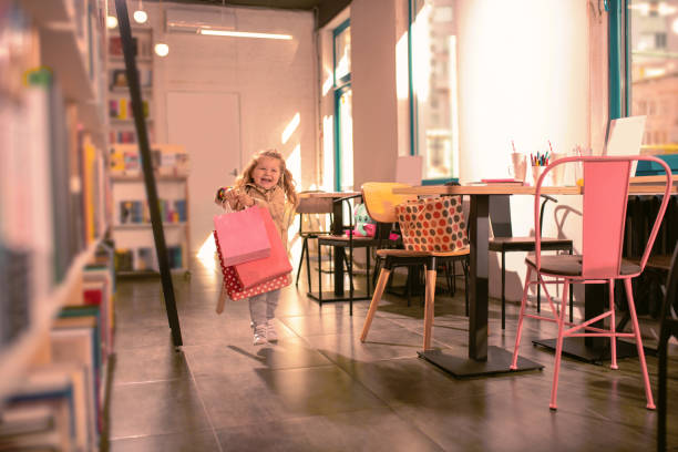 amazing baby girl feeling happiness while being in cafe - foster home bag imagens e fotografias de stock