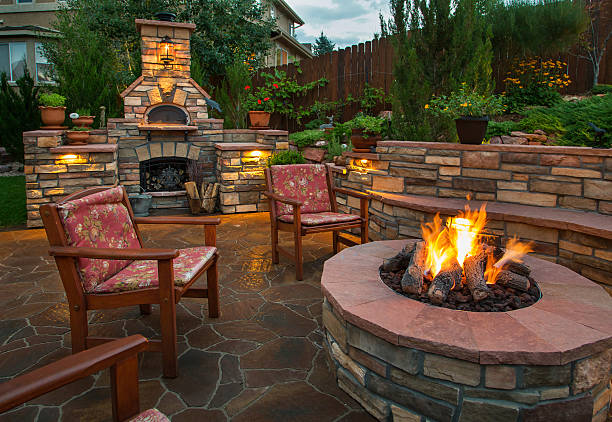 amazing backyard with pizza oven and fire pit Beautiful backyard at twilight that includes a pizza oven and fire pit. fire pit stock pictures, royalty-free photos & images