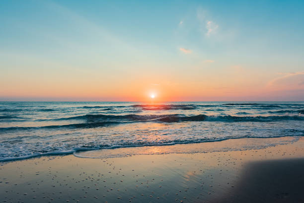 Amazing colorful sunrise at sea Amazing colorful sunrise at sea, early morning on the beach seascape stock pictures, royalty-free photos & images