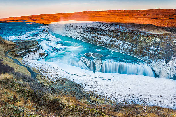 Amazing Icelandic winter landscape of majestic waterfall of frozen Gullfoss stock photo