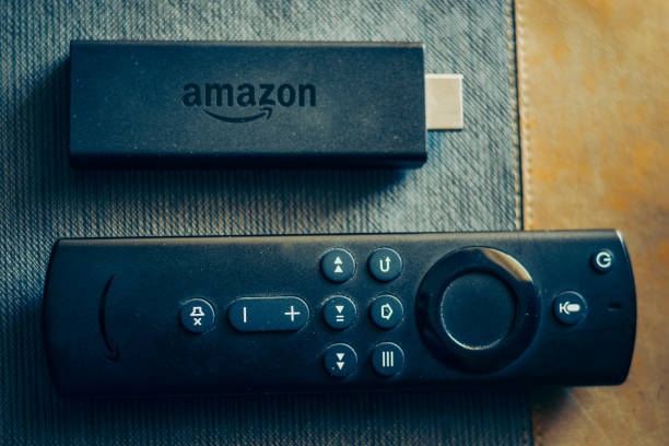 Amazon fire stick TV remote in hand Amazon fire stick TV remote in hand amazon fire stick tv stock pictures, royalty-free photos & images