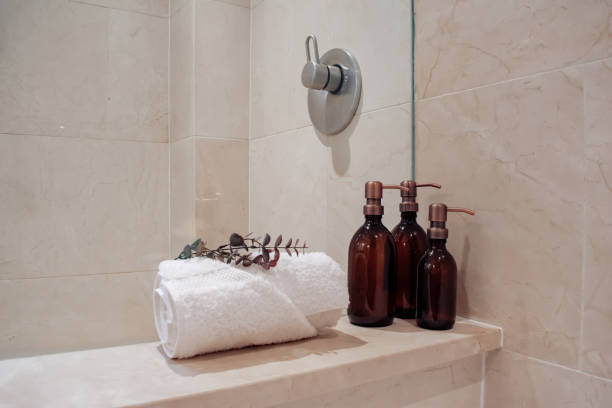 Amber glass shampoo bottles in a luxury minimalist bathroom. stock photo
