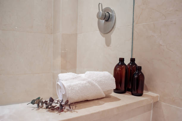 Amber glass shampoo bottles in a luxury minimalist bathroom. stock photo