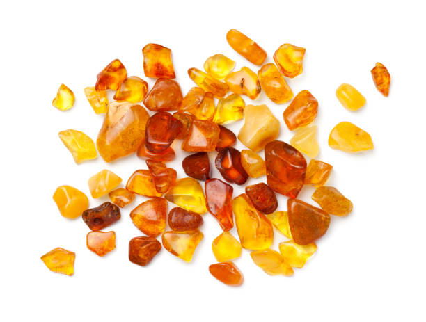 Ambers Isolated On White Background Ambers isolated on white background. Pieces of polished amber. Top view, flat lay semi precious gem stock pictures, royalty-free photos & images