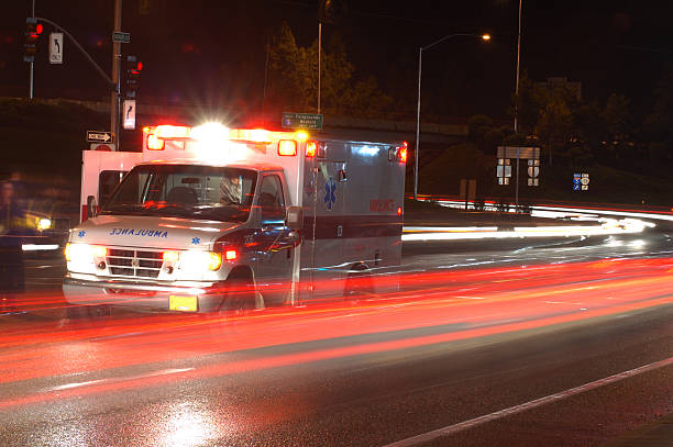 ambulance in traffic - ambulance stok fotoğraflar ve resimler