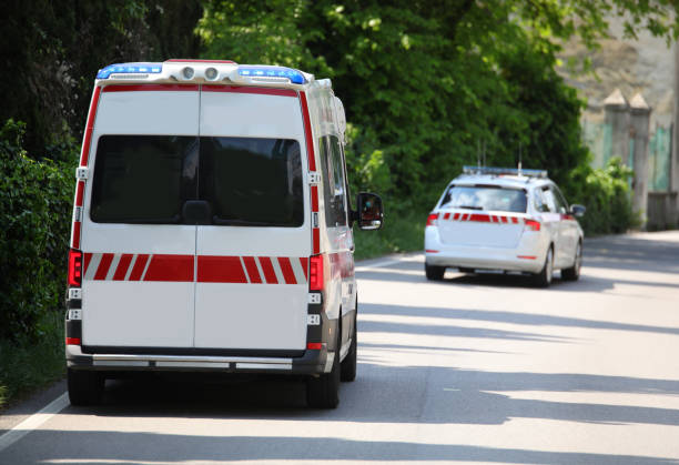 ambulance runs fast on the road preceded by the very fast medical car call for the health emergency stock photo