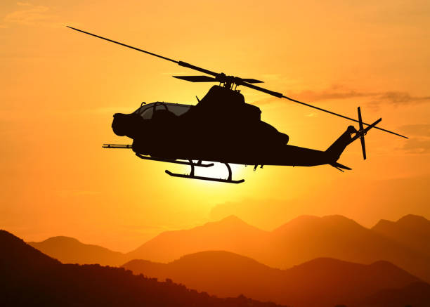 American attack helicopter silhouette in the flight stock photo