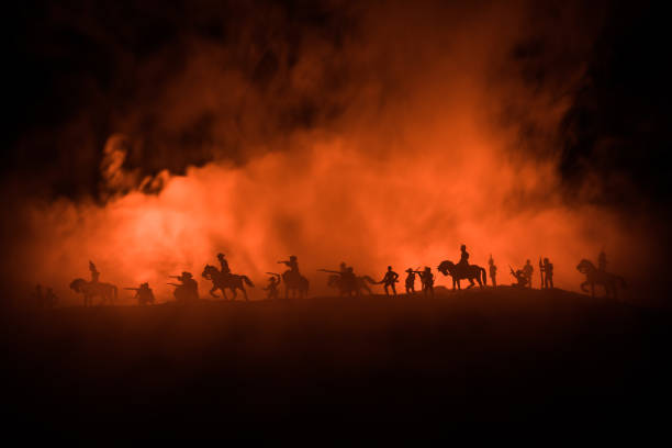 American Civil War Concept. Military silhouettes fighting scene on war fog sky background. Attack scene. stock photo