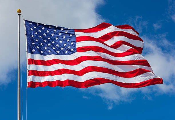 American flag against the sky stock photo