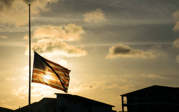 American Flag at Half Mast after another School Shooting A Scary future for America stock photo