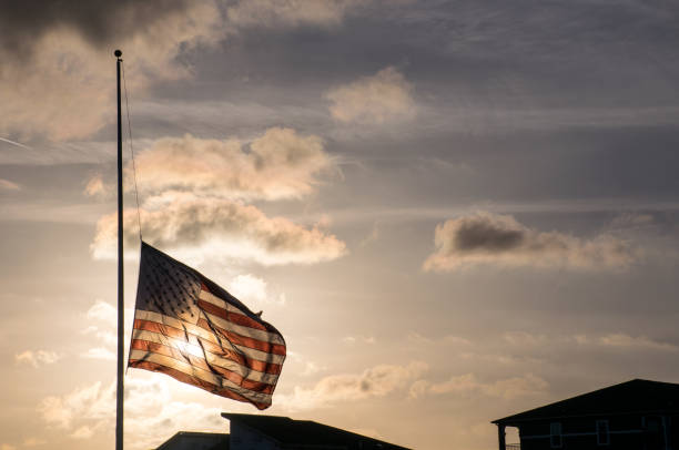 American Flag at Half Mast after another School Shooting dark future with Guns in America American Flag at Half Mast after another School Shooting dark future with Guns in America after another School Shooting in Florida 2018 flag at half staff stock pictures, royalty-free photos & images