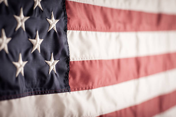 American Flag Background with Vintage Feel Close up color image of an American flag. Some desaturation and grain added for vintage feel. memorial day background stock pictures, royalty-free photos & images