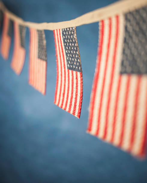 American flag banners American flag banners against blue background memorial day background stock pictures, royalty-free photos & images