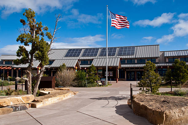 American Flag Flies in Front of Grand Canyon Visitor Center Grand Canyon National Park, Arizona, USA - May 17, 2011: The American flag flies in front of the Grand Canyon Visitor Center at Mather Point. jeff goulden southwest usa stock pictures, royalty-free photos & images