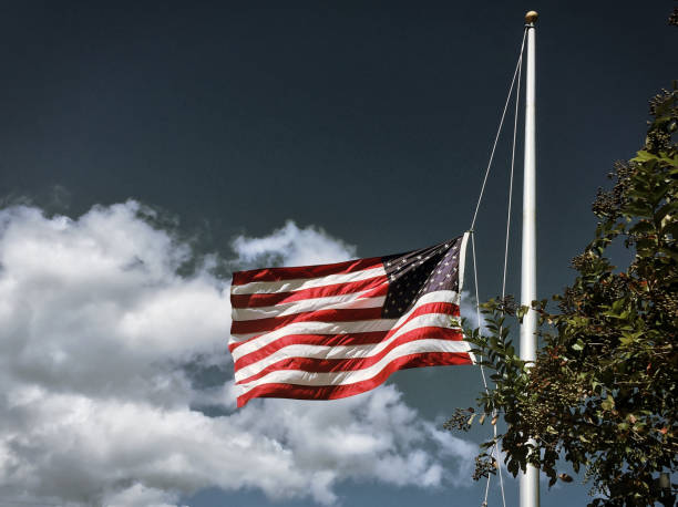 American Flag Half-Mast An American flag flies at half-mast after the tragedy in Las Vegas on 10/1/2017. flag at half staff stock pictures, royalty-free photos & images