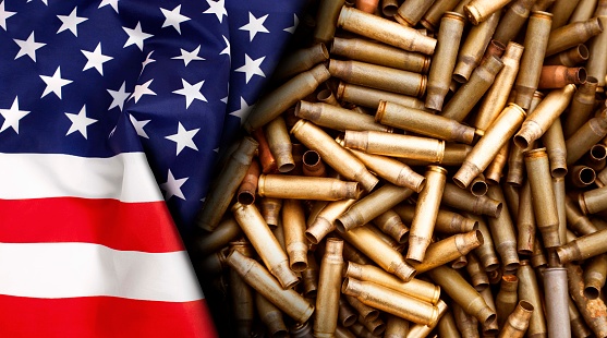 American flag isolated on shotgun cartridges background. Top view, copy space for text.