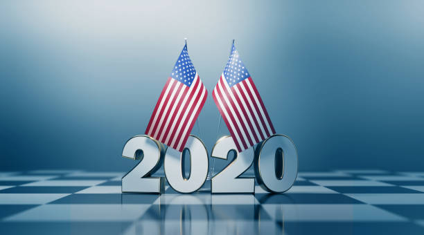 American flag pair and 2020 on a chess board. Horizontal composition with copy space and selective focus. 2020 presidential elections concept.