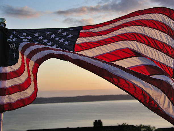 American Flag American flag waving at sunset 1776 american flag stock pictures, royalty-free photos & images