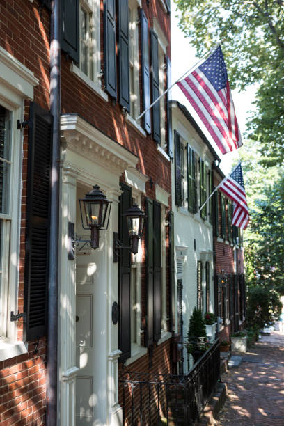 American flags displayed on historic 18th century home in Alexandria, VA stock photo