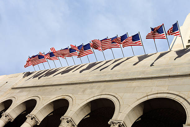 American Flags Flying over a building stock photo
