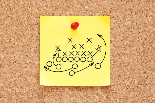 American Football Playbook Tactics Sticky Note American football or rugby game playbook, strategy or tactics drawn on yellow sticky note pinned on bulletin cork board. defending sport stock pictures, royalty-free photos & images