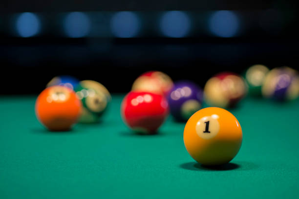 American pool balls on a pool table with number two in focus Yellow ball number 1 is focused and the rest of the balls are out of focus cue ball stock pictures, royalty-free photos & images