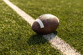 istock American rugby ball on the grass in the stadium 1317493024