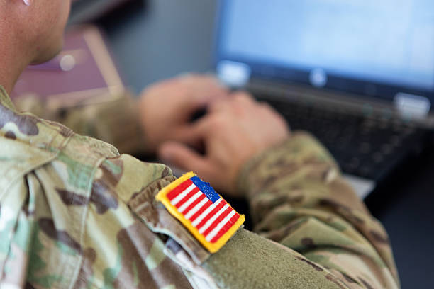 American soldier working on laptop unrecognizable American soldier writing on a laptop us military stock pictures, royalty-free photos & images