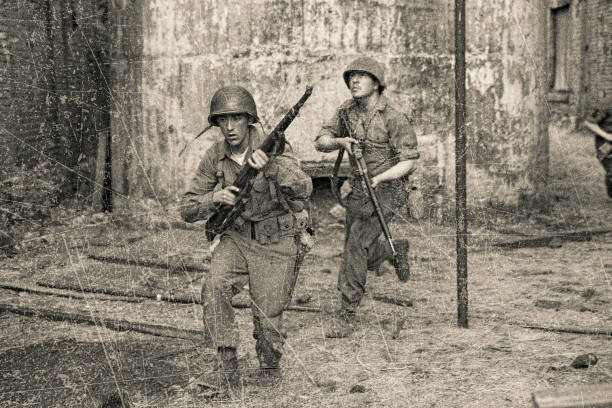 WWII American soldiers in combat Antique sepia photo of WWII American soldiers in combat historical reenactment stock pictures, royalty-free photos & images