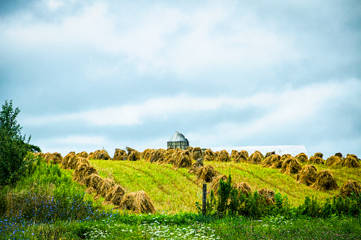 Amish Farm with Hay Stacks and a barn roof  and silo.