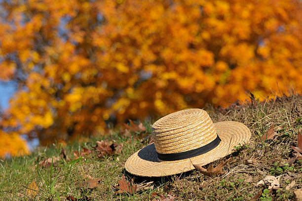Amish Hat Laying Over Fall Leaves stock photo