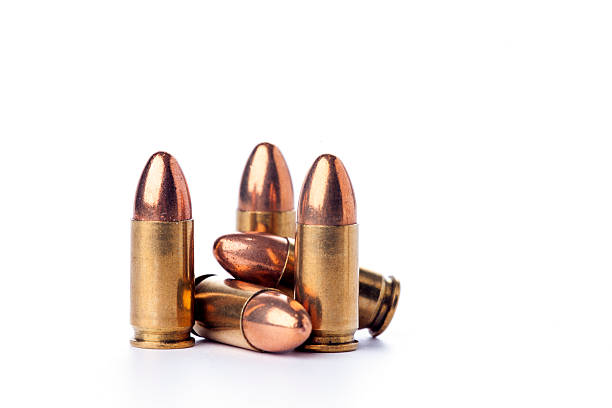 ammunition A group of 9mm bullets for a a gun isolated on a white background ammunition stock pictures, royalty-free photos & images