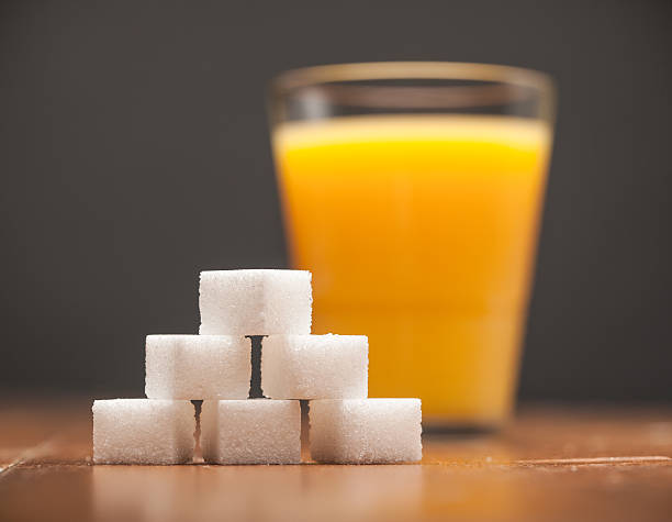 Amounts of Sugar In Food - Glass of Orange Juice stock photo
