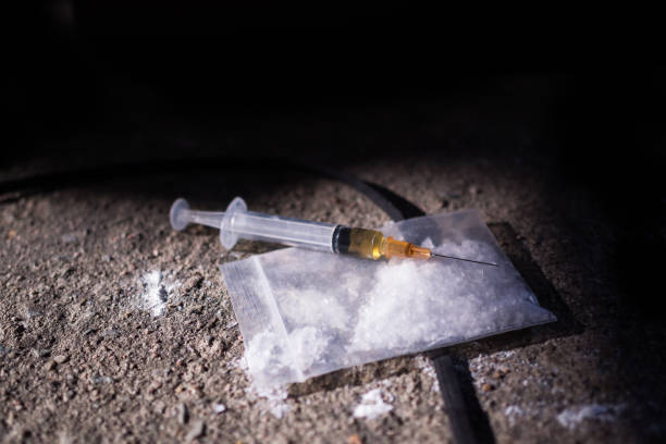 Amphetamine and syringe on black background. Substance abuse concept.copy space. Amphetamine and syringe on black background. Substance abuse concept.copy space. amphetamine stock pictures, royalty-free photos & images