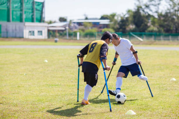 Amputee football match Two Japanese amputee football player are trying to get the ball from each other. soccer striker stock pictures, royalty-free photos & images