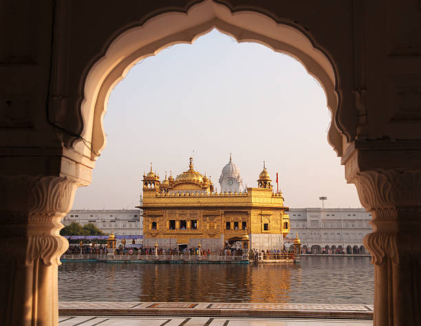 Amritsar Golden Temple - India. Amritsar Golden Temple - India. Framed with windows from west side. focus on temple pilgrims monument stock pictures, royalty-free photos & images