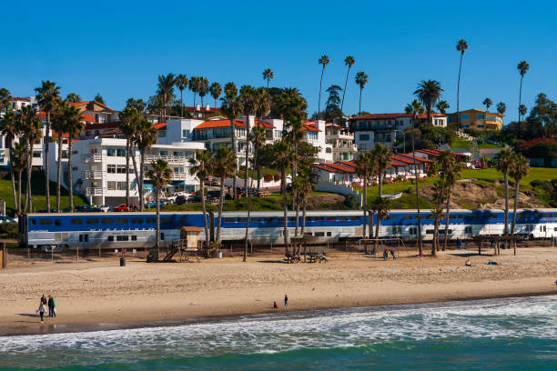 Amtrak's Pacific Surfliner, traveling south on the west coast through San Clemente, Southern California, on a cloudless, winter day. stock photo