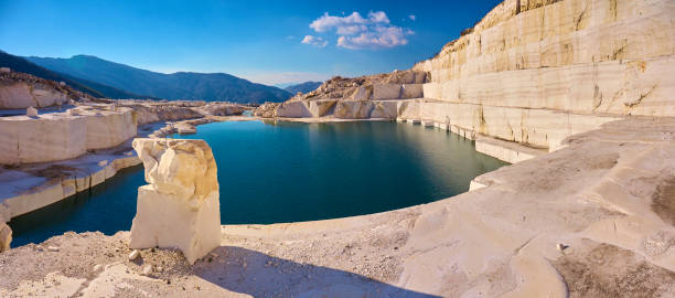 An abandoned marble quarry and a lake in the middle of the quarry. stock photo