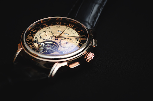 An accessory for men. Mechanical watch on a dark background