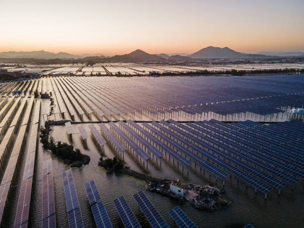 An aerial view of a solar power plant in the sea at sunset. stock photo