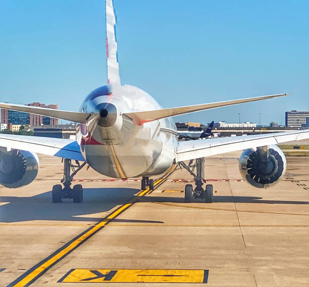 An Airplane Sits on the Tarmac in Dallas An airplane waits to take off from the Dallas Ft. Worth Airport in Dallas Texas. michael dean shelton stock pictures, royalty-free photos & images