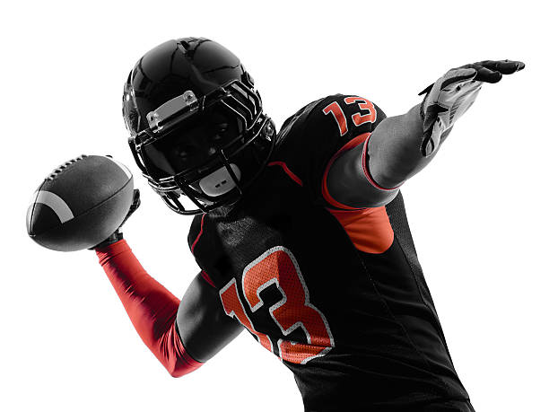 An American football player throwing the football one american football player quarterback passing portrait in silhouette shadow on white background american football player stock pictures, royalty-free photos & images